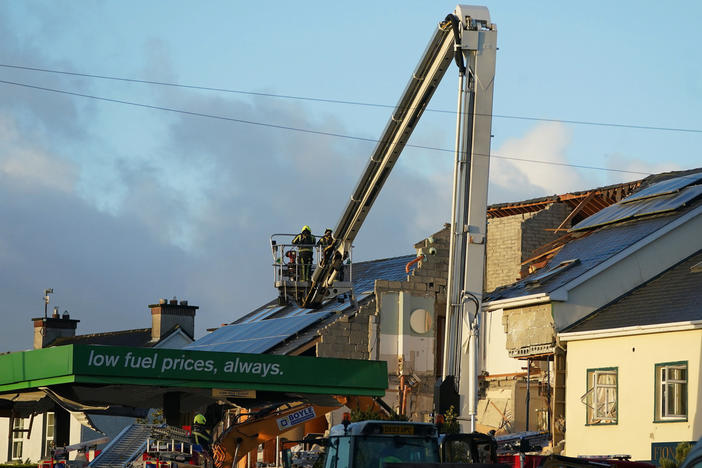 Emergency services work at the scene of an explosion that killed 10 people at a service station in the village of Creeslough in County Donegal, Ireland, on Saturday.