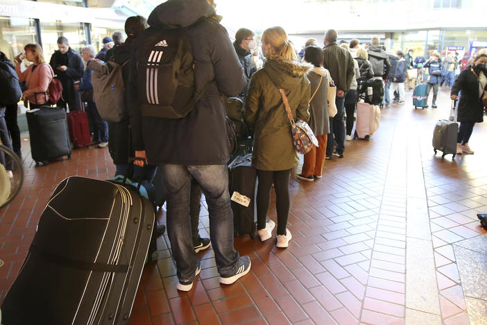 Travelers stand in long lines at the travel center in Hamburg Central Station after long-distance services in northern Germany came to a standstill, Hamburg, Germany, on Saturday.