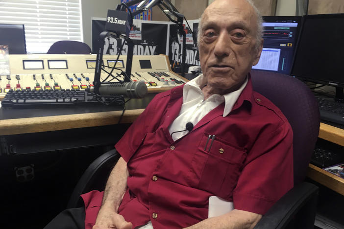 DJ Art Laboe sits in his studio and talks about his 75 years in the radio business in 2018, in Palm Springs, Calif. Laboe, a pioneering disc jockey who hosted a syndicated oldies show for decades, died on Friday.