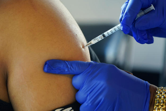 A Jackson, Miss., resident receives a Pfizer booster shot from a nurse at a vaccination site Feb. 8.