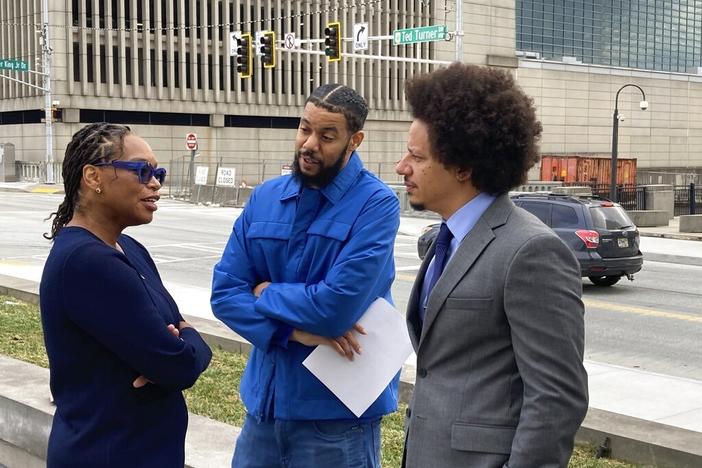 Comedians Clayton English, center, and Eric Andre, right, speak with their attorney, Allegra Lawrence-Hardy, on Tuesday outside the federal courthouse in Atlanta.