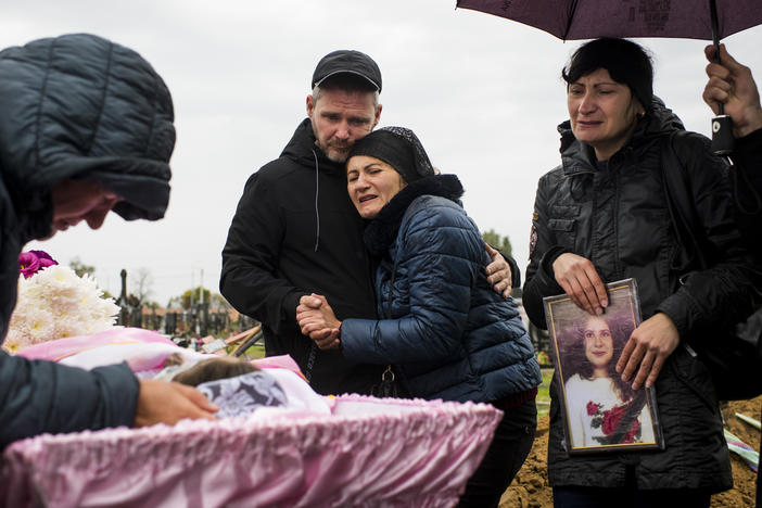 Andriy and Iryna Grycenko (center) mourn the death of their 11-year-old daughter, Anastasiya, at her funeral in Kharkiv, Ukraine, on Sept. 20. Anastasiya was killed on Sept. 17 when a Russian S-300 missile obliterated her home in Chuhuiv. At right is Iryna's sister, Anastasiya's aunt, Rimma Leiba.
