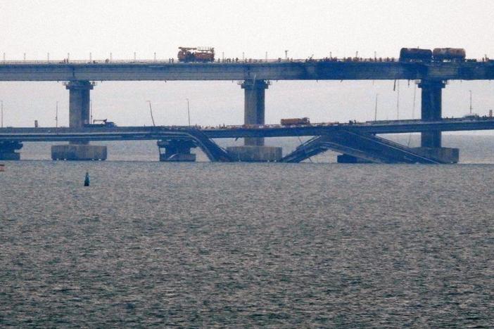 Workers restore the railway tracks Sunday on the Kerch bridge that links Crimea to Russia, a day after it was damaged by a blast. Officials said car and train traffic had resumed over the bridge, with Moscow's transport ministry saying Sunday that long-distance passenger trains from Crimea to Russia were "moving according to the standard schedule."