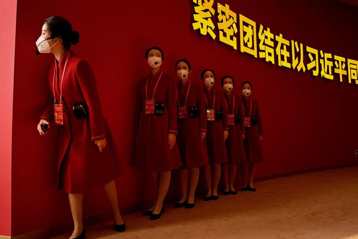Attendants wait to guide visitors to the the exhibition entitled "Forging Ahead in the New Era," highlighting Chinese President Xi Jinping's years as leader, at the Beijing Exhibition Center in Beijing, ahead of the 20th Communist Party Congress meeting.