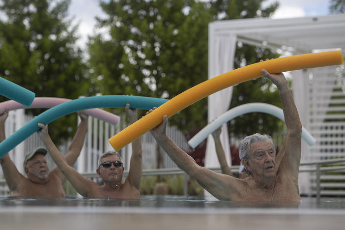 Kevin Soyt, Robert Hamilton and Dave Bayer participate in a water aerobics class in the John Knox Village Continuing Care Retirement Community pool on Oct. 15, 2021 in Pompano Beach, Fla. The Social Security Administration announced the largest cost-of-living adjustment in decades: 8.7%.