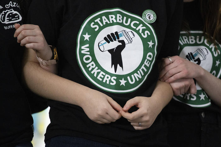 Starbucks employees and supporters react as votes are read during a union-election watch party in 2021 in Buffalo, N.Y. Starbucks workers voted to unionize over the company's objections, pointing the way to a new labor model for the 50-year-old coffee giant.