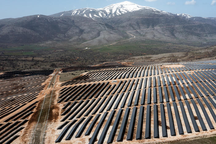 An array of photovoltaic panels are pictured at a solar power park in Kozani, Greece on April 6, 2022. Greece's power transmission operator says it recently hit a new benchmark, using exclusively renewable energy for a brief time.