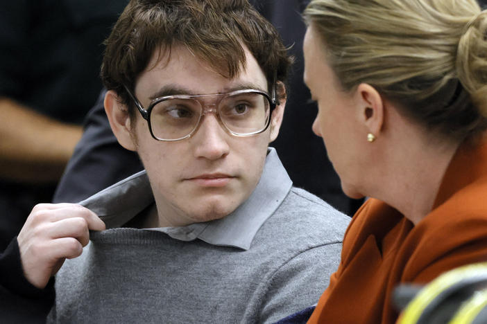 Marjory Stoneman Douglas High School shooter Nikolas Cruz tugs at his shirt collar at the defense table for the verdict in his trial at the Broward County Courthouse on Thursday in Fort Lauderdale, Fla. The jury recommended Cruz receive a life sentence.