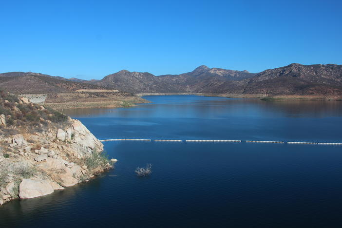 The San Vicente reservoir in San Diego County stores water from as far away as the Colorado River. Pumping water into a smaller reservoir in the surrounding mountains could store excess solar power until it's needed, when the sun sets.