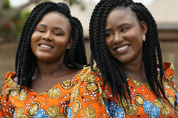 Twins Kehinde Adamolekun, left, and Taiwo Adamolekun, 28, attend the annual twins festival in Igbo-Ora South west Nigeria, Saturday, Oct. 8, 2022.