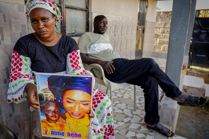 Mariama Kuyateh, 30, holds up a picture of her son Musa, whose death from acute kidney failure on Oct. 10 was linked to contaminated cough syrup imported to Gambia, where they live, from India. The World Health Organization issued an alert about the medication.