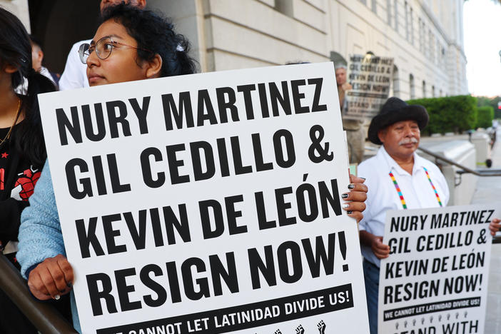 Protesters outside City Hall call for the resignations of LA City Council members Kevin de Leon and Gil Cedillo on Wednesday.