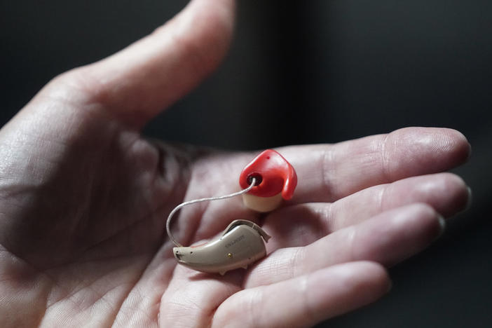 Chelle Wyatt holds her hearing aid on April 15, 2022, in Salt Lake City.