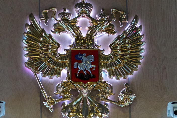 The emblem for the Russian Defense Ministry is displayed at the ministry's building in Moscow. Officials say 11 soldiers were killed and 15 wounded in a shooting at a military facility near Ukraine.