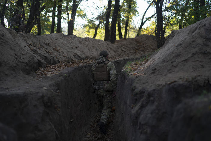 A Ukrainian serviceman checks the trenches dug by Russian soldiers in a retaken area in the Kherson region, Ukraine, on Oct. 12, 2022.