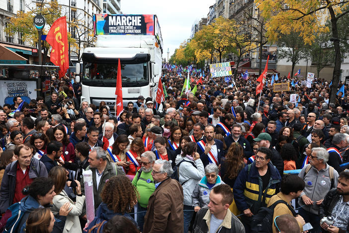 People gather for a protest march against the high cost of living and climate inaction in Paris on Sunday.