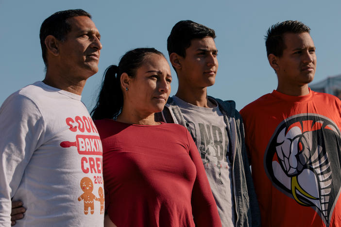 Victor Villegas, Milagros Pineda,  Daniel Villegas, and Leiver Villegas, stand for a portrait in Brooklyn, New York, U.S., on Tuesday, October 11, 2022.