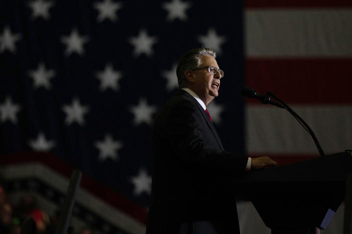 Matthew DePerno, the Republican nominee for Michigan attorney general, speaks during a Trump rally on Oct. 1 in Warren, Mich. DePerno is being investigated for his involvement in an alleged scheme to tamper with voting machines.