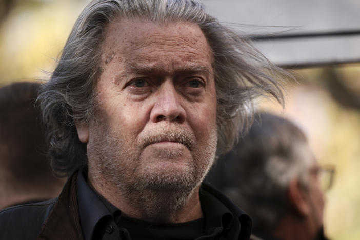 Former Trump administration White House adviser Steve Bannon listens as attorney David Schoen speaks to reporters outside of the E. Barrett Prettyman Federal District Court House on Nov. 15, 2021.