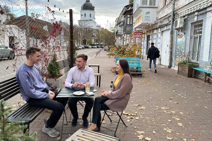From left: Ivan Sushchyk, Vadym Zahozytsky and Yana Yelizarova discuss U.S. support for the war in Ukraine at a coffee shop in Kyiv on Oct. 11.