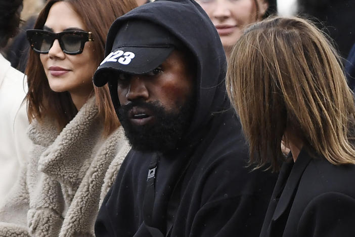 Ye (C), formerly known as Kanye West, attends the Givenchy Spring-Summer 2023 fashion show during the Paris Womenswear Fashion Week, in Paris, on Oct. 2, 2022.