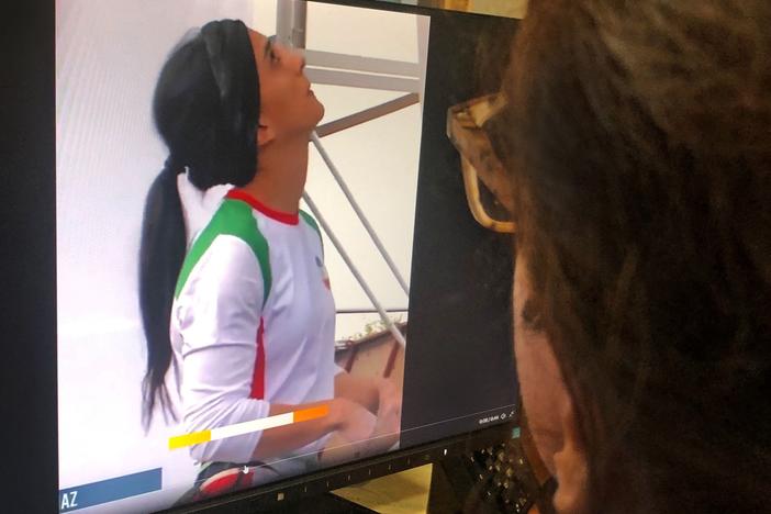 A woman in the Cypriot capital of Nicosia watches a video of Iranian climber Elnaz Rekabi competing without a hijab at an international climbing competition in Seoul, South Korea.