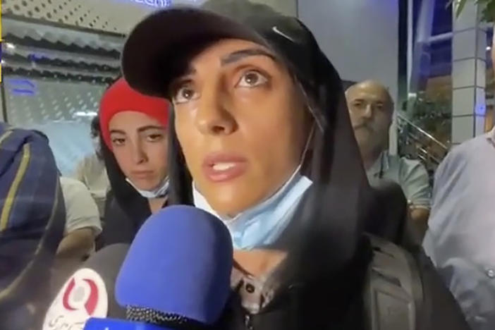 In this image taken from video by Iran's state-run IRNA news agency, Iranian competitive climber Elnaz Rekabi speaks to journalists in Imam Khomeini International Airport in Tehran, Iran, Wednesday, Oct. 19, 2022.