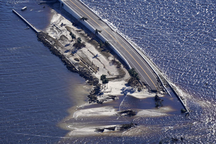 In this aerial photo made in a flight provided by mediccorps.org, damage from Hurricane Ian is seen on the causeway leading to Sanibel Island from Fort Myers, Fla., on Sept. 30. The causeway has reopened with temporary repairs.