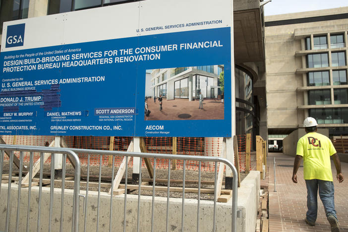 A sign stands at the construction site for the Consumer Financial Protection Bureau's new headquarters in Washington, Monday, Aug. 27, 2018.