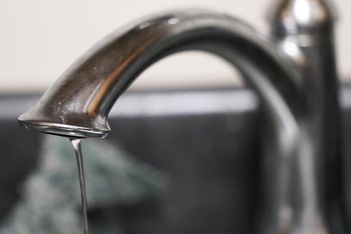 A trickle of water comes out of the faucet of Mary Gaines a resident of the Golden Keys Senior Living apartments in her kitchen in Jackson, Miss., Sept. 1, 2022.
