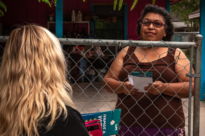 Yesenia Monisvais speaks to a member of LUPE as they canvass in San Juan, Texas, on Oct. 4.