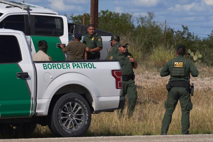 A migrant found smuggled in a vehicle is apprehended by U.S. Border Patrol and the Webb County Sheriff on Oct. 12 in Laredo, Texas.
