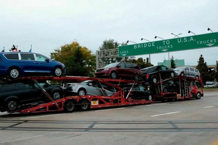 A car hauler carrying Chrysler Pacificas' approaches the Ambassador Bridge that connects Windsor, Canada, to Detroit, Michigan,on October 5, 2018 in Windsor, Ontario, Canada.