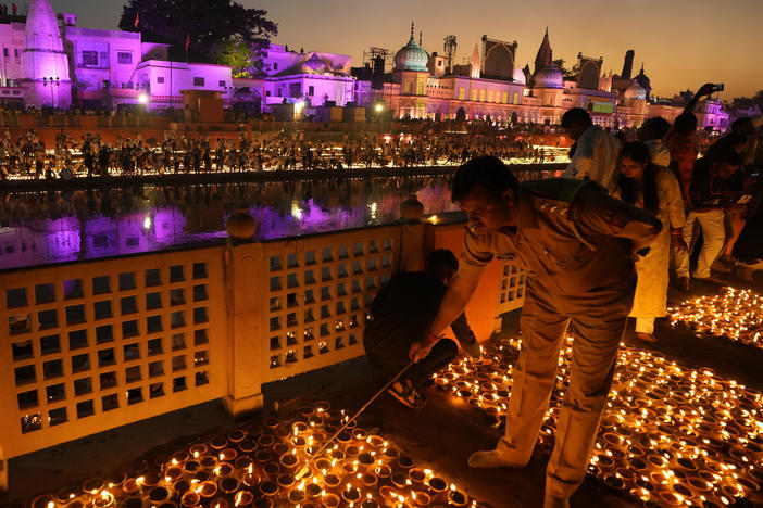 People light lamps on the banks of the river Saryu in Ayodhya, India, Sunday, Oct. 23, 2022.