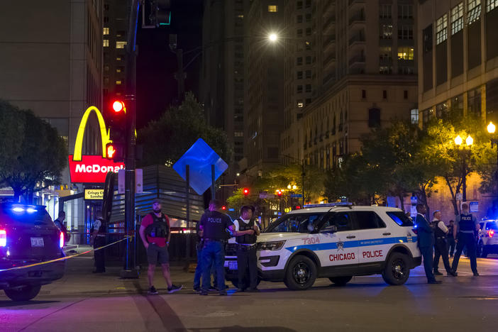 Chicago police officers arrive at the scene of a May 19 mass shooting outside a McDonald's restaurant.