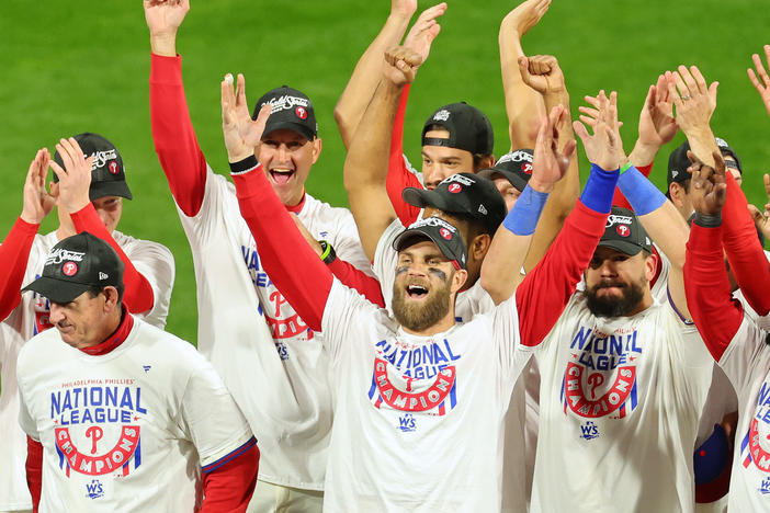 Bryce Harper, center, of the Philadelphia Phillies celebrates with teammates after defeating the San Diego Padres in game five to win the National League Championship Series at Citizens Bank Park on October 23, 2022 in Philadelphia.