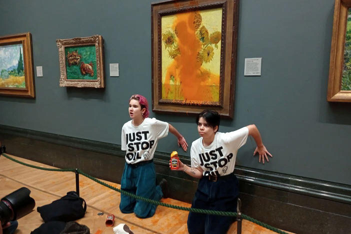 Just Stop Oil activists glue their hands to the wall after throwing soup at Vincent van Gogh's "Sunflowers" at the National Gallery in London earlier this month. Museums and famous artworks have long been the site of public protests.
