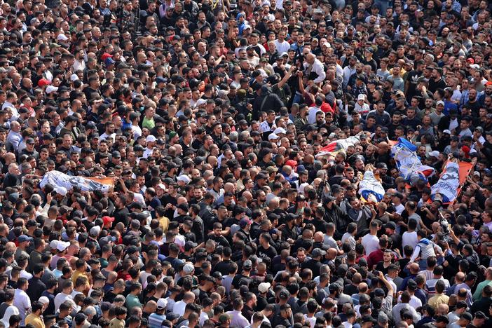 Mourners attend the funeral of Palestinians killed in an overnight Israeli raid in the occupied West Bank city of Nablus on Tuesday. The Israeli army said it was targeting an emerging armed group called Lions' Den.