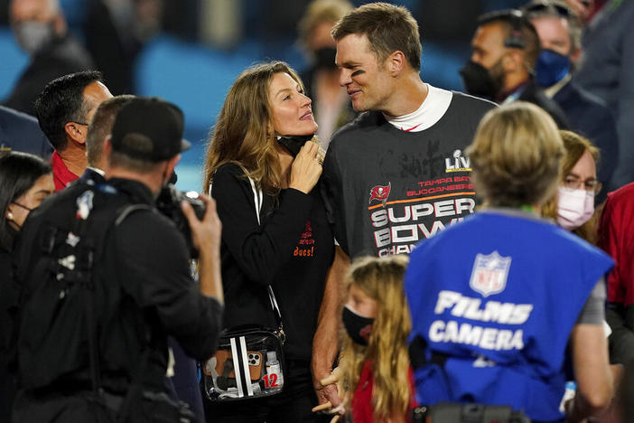 Tampa Bay Buccaneers quarterback Tom Brady walks with Gisele Bundchen on the field in February 2021 after winning the Super Bowl against the Kansas City Chiefs.