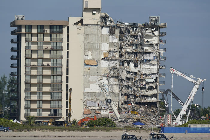 Coast Guard boats patrol in front of the partially collapsed Champlain Towers South condo building in Surfside, Fla. in July 2021. Residents of a Miami Beach building on the same street were forced to evacuate on Thursday evening.