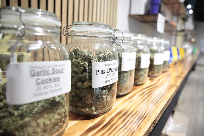 Jars of marijuana line a shelf at The Flower Shop Dispensary in Sioux Falls, S.D. on Oct. 14, 2022. South Dakota's legal pot industry has started with medical cannabis, but voters are deciding whether to also legalize recreational pot.
