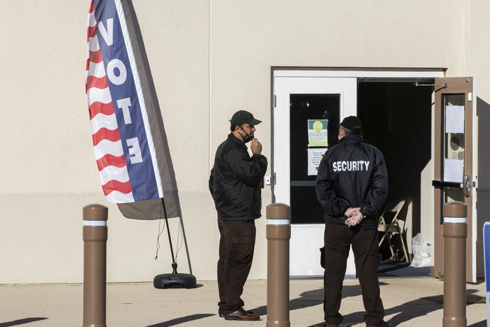 Security personnel wait for voters outside the Leon County Supervisor of Elections office on Nov. 3, 2020, in Tallahassee, Fla.