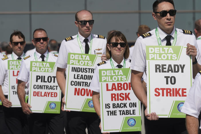 Off-duty Delta Air Lines pilots picket at Salt Lake City International Airport Thursday, June 30, 2022, in Salt Lake City.