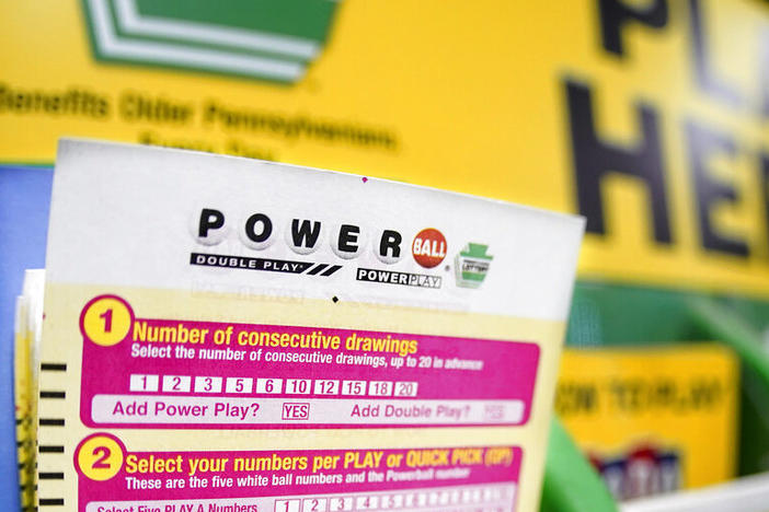 A rack with cards bettors can use to choose their own numbers for the Powerball lottery is seen Friday on a counter at a market in Prospect, Pa.