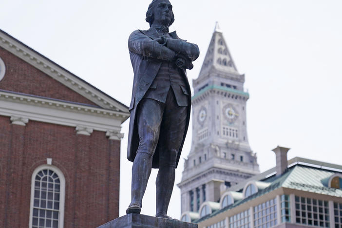 The statue of Samuel Adams stands outside Boston's Faneuil Hall.
