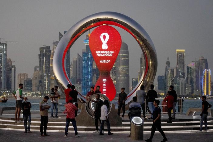 People gather in November 2021 around the official countdown clock showing remaining time until the kick-off of the World Cup 2022 in Doha, Qatar.