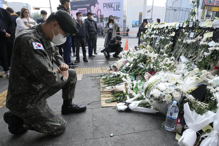 A South Korean army soldier pays tribute to victims of a deadly accident following Saturday night's Halloween festivities on a street near the scene in Seoul, South Korea, Tuesday, Nov. 1, 2022.