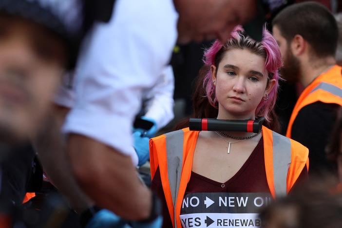 Phoebe Plummer, pictured at a demonstration in London's Piccadilly Circus in early October, spoke to <em>Morning Edition</em> about the tactics Just Stop Oil is using to draw attention to the urgency of climate change.