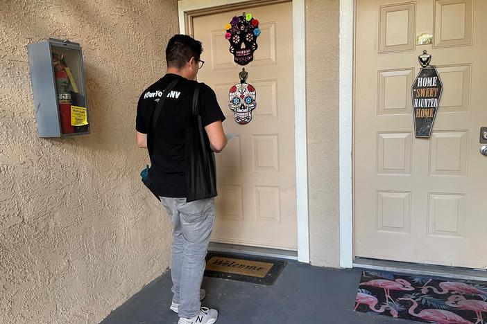 Progressive Activist LaLo Montoya knocks on a door in a Las Vegas apartment complex to help get out the vote ahead of Election Day.