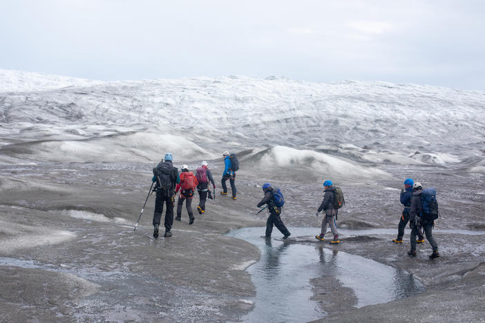 A group of scientists from the United Kingdom trek up to a research site on the west side of the Greenland ice sheet near Kangerlussuaq in the summer of 2022. This year marks the 26th year that Greenland has lost more ice than it gained.